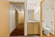 a bathroom with a toilet and a sink and a mirror