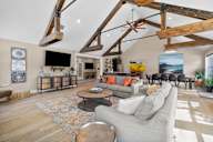 a living room with couches and chairs and a tv