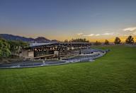 a view of a stadium at sunset with mountains in the background