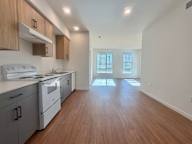 A kitchen with white appliances and wooden cabinets.