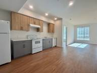 A kitchen with wooden cabinets and a white refrigerator.