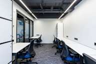 A row of chairs are lined up in a room.