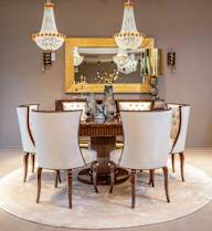 A dining room with a large table and chairs.