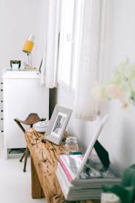A white dresser with a lamp and a picture frame on top of it.