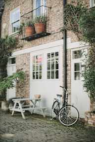 A bicycle is parked next to a white door.