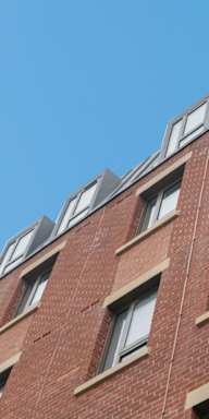 the top of a brick building with windows