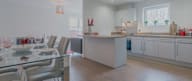 a kitchen and dining room with a table and chairs