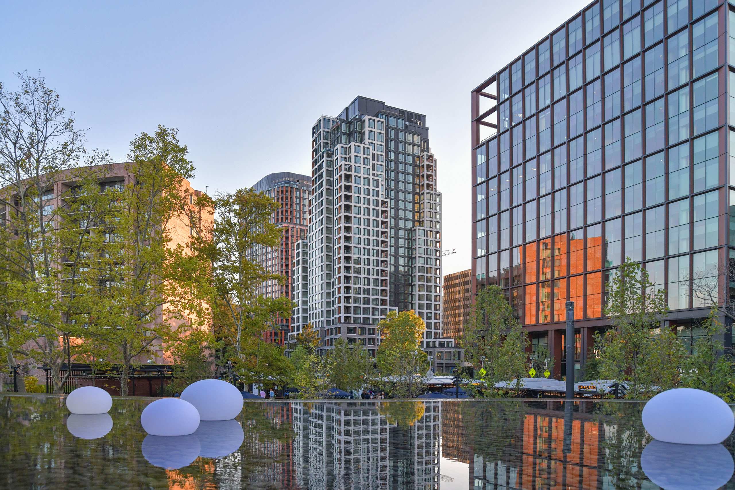 National Landing skyline and residential towers reflected in the Metropolitan Park water feature