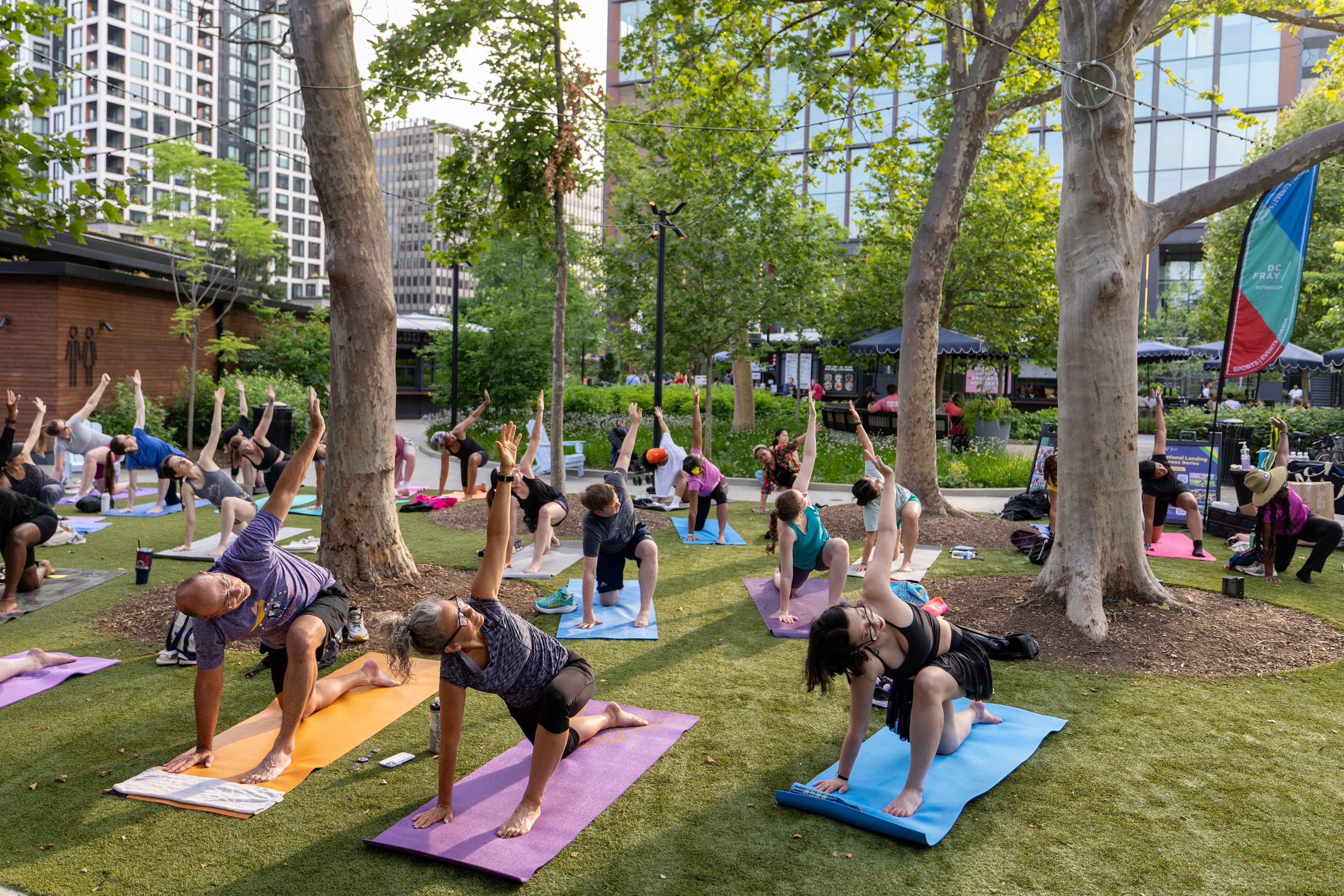 Outdoor fitness class on the lawn at a National Landing park