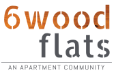 the logo for wood flats an apartment community