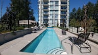 a swimming pool in front of an apartment building