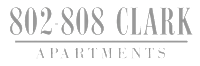 The image shows a sign for 802-808 Clark Apartments.