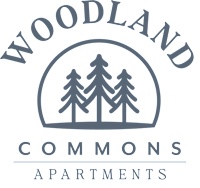 The image is a logo for Woodland Commons Apartments.