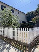 a white picket fence in front of a house