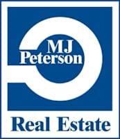A blue and white logo for MJ Peterson Real Estate.