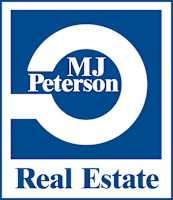 A blue and white logo for MJ Peterson Real Estate.
