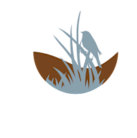 The image is a logo for "The Prairie Luxury Villas" featuring a bird and grass silhouette.