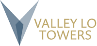 A logo with a blue triangle and the words "Valley Towers" in gold.