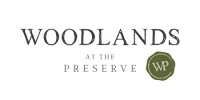 A logo with the text "Woodlands at the Preserve" and a circular emblem with the letters "WP" inside it.