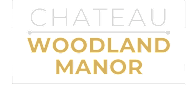 A green sign with the words "Chateau Woodland Manor" written in white.