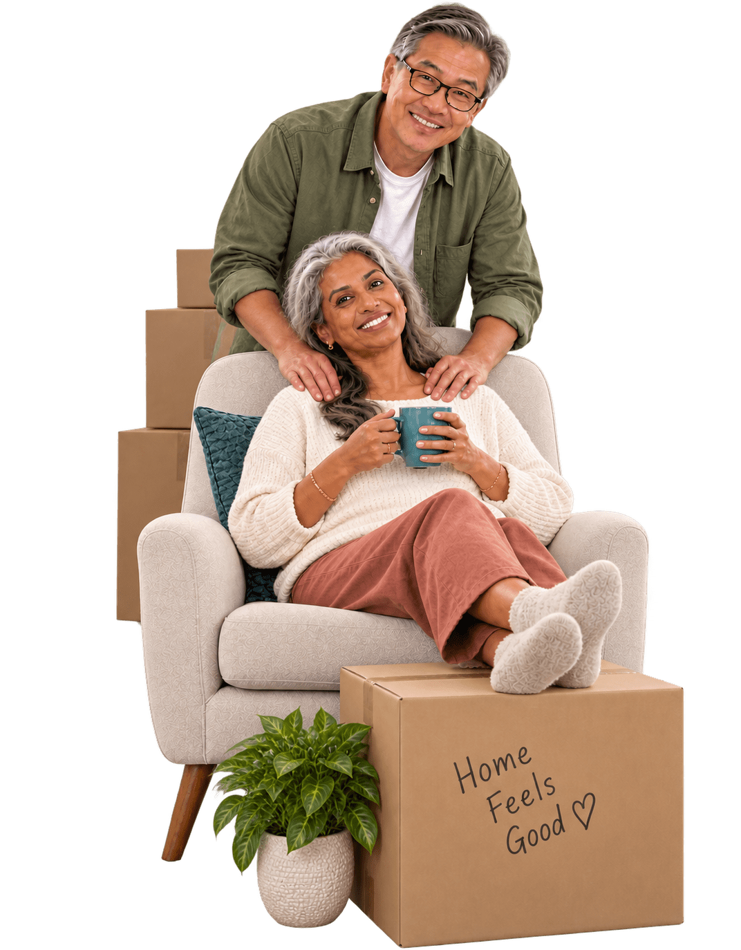A couple relaxing in their new home beside a moving box that reads Home Feels Good