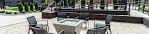 A patio with a table and chairs and a fountain.