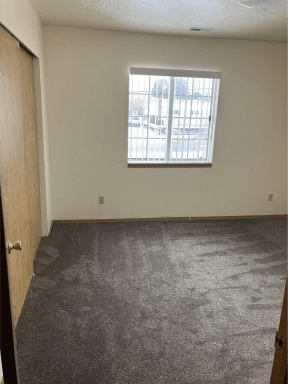 the living room of an empty house with a window