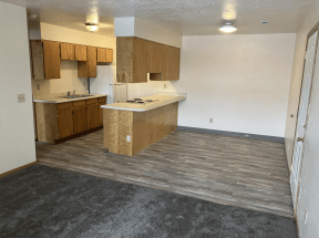an empty kitchen with an island in the middle of it