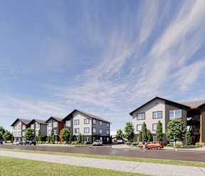 A row of modern townhouses with cars parked in front.