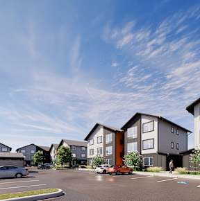 A modern apartment complex with a parking lot in front.