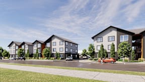 A row of modern townhouses with cars parked in front.