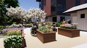 A group of people are sitting on a bench in a garden.