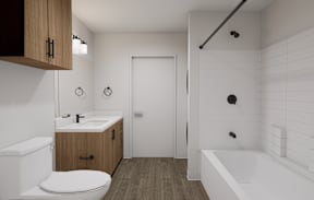 A white toilet sits in a bathroom with a white tub and a white sink.