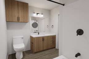 A white toilet sits next to a sink in a small bathroom.