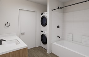 A white bathroom with a washing machine built into the wall.