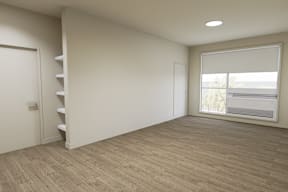 A room with a window and a staircase.