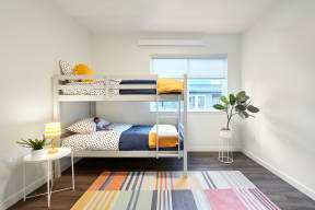 a bedroom with a bunk bed and a window
