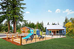 a playground with a swing set and a pavilion