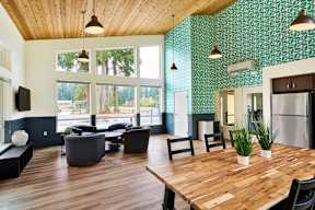 a large living room with a wooden table and chairs
