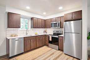 a kitchen with stainless steel appliances and wooden cabinets