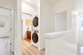 a living room with a washer and dryer in it