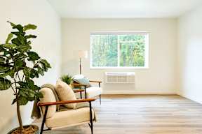 a living room with a chair and a window