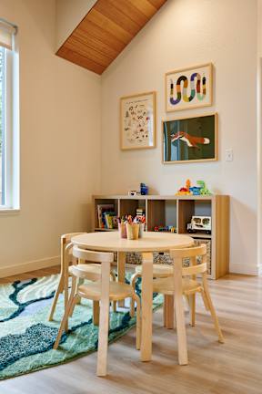 A dining room with a table and chairs.