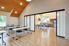 A conference room with a long table and chairs.