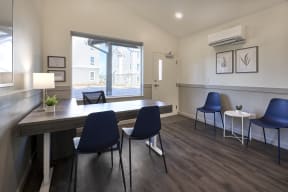 a dining room with a table and chairs and a window