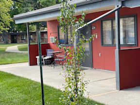 A red building with a white door and windows.