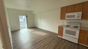 A kitchen with a white oven and microwave above it.