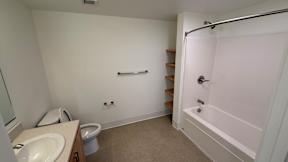 A white bathroom with a sink, toilet, and bathtub.