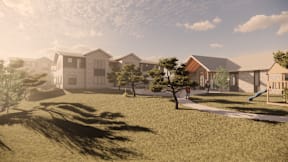 A sunny day in a residential area with houses and a playground.