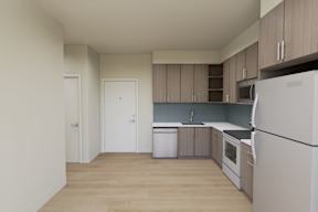 A kitchen with white appliances and wooden cabinets.